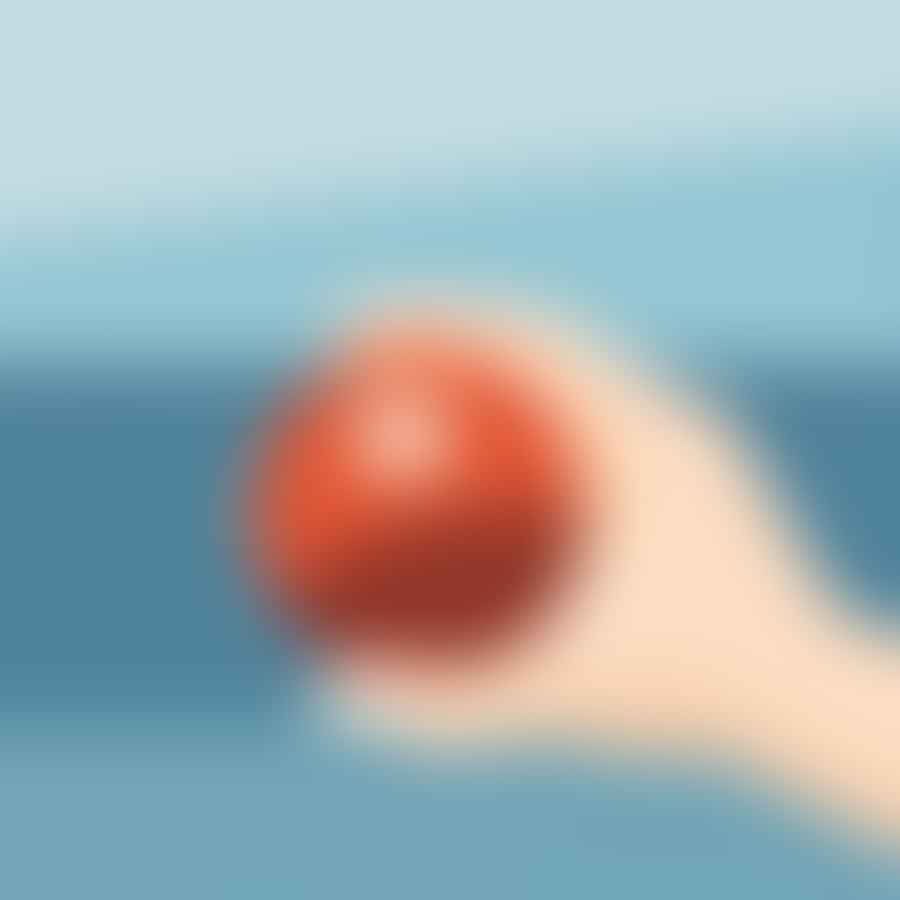 A close-up of a hand properly gripping a bocce ball